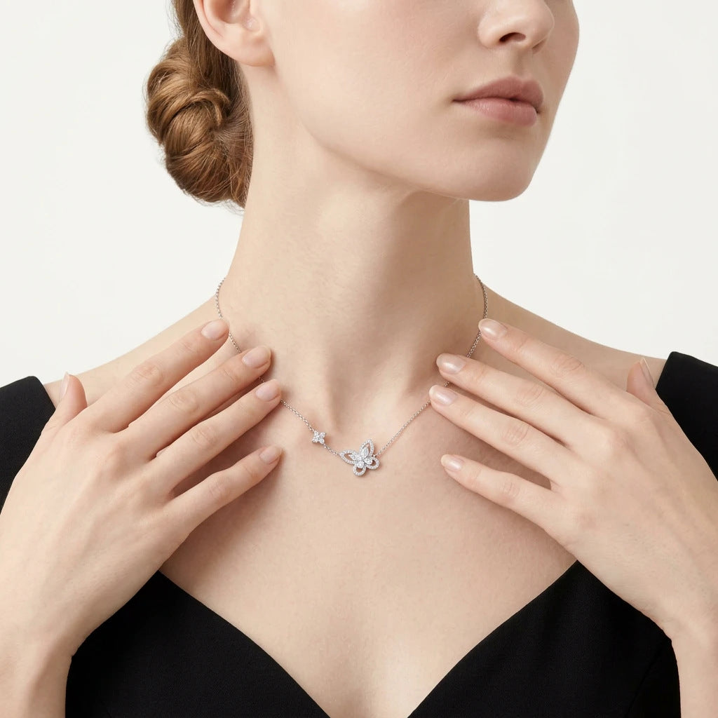 Model wearing marquise and pavé moissanite butterfly floral station necklace.
