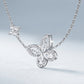 Perspective view of marquise and pavé moissanite butterfly floral necklace on slate background.