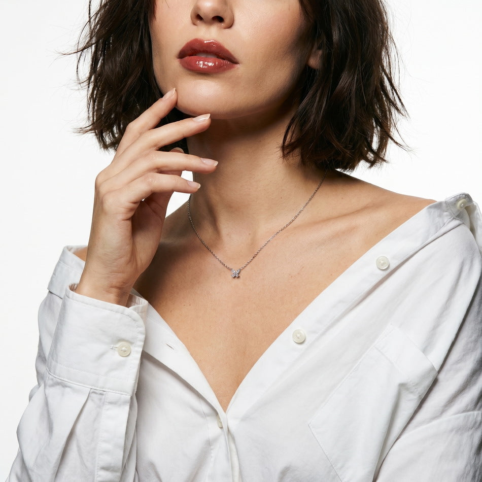 Model wearing marquise and pear cut lab grown diamond butterfly pendant necklace.