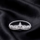 Front view of marquise and round lab grown diamond curved wishbone ring on dark black silk