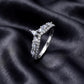 Angled side profile of lab grown diamond curved wishbone wedding band on black silk fabric