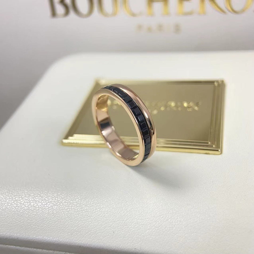 Symmetrical view of a minimalist black ceramic stackable wedding band paired with a luxury rose gold plated band.