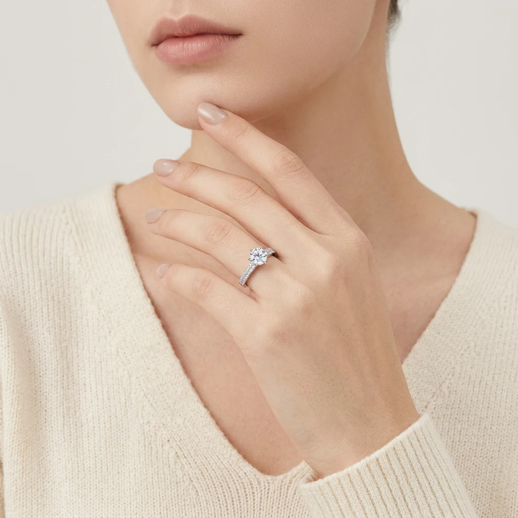 Editorial fashion lookbook portrait of a model styling a minimalist romantic double pave shank moissanite heirloom jewelry piece with a sweater.