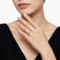 Sophisticated lifestyle portrait of a model showcasing a minimalist romantic round cut cz alternative wedding ring with a black dress.
