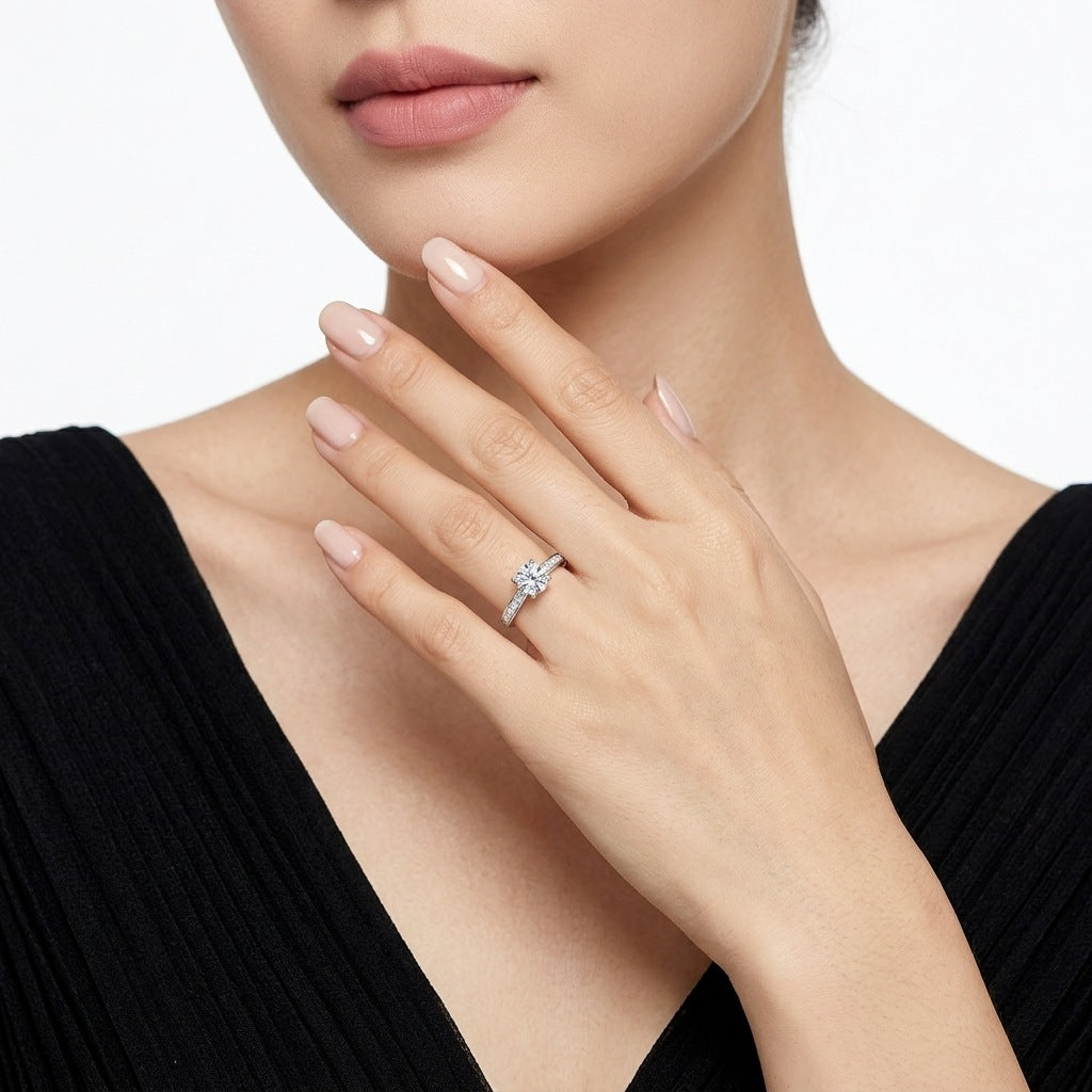 Sophisticated lifestyle portrait of a model showcasing a minimalist romantic round cut cz alternative wedding ring with a black dress.