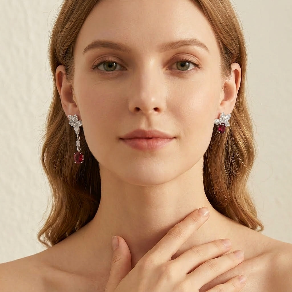 Frontal editorial portrait of a model showcasing the minimalist ruby mismatched leaf earrings for styling reference.