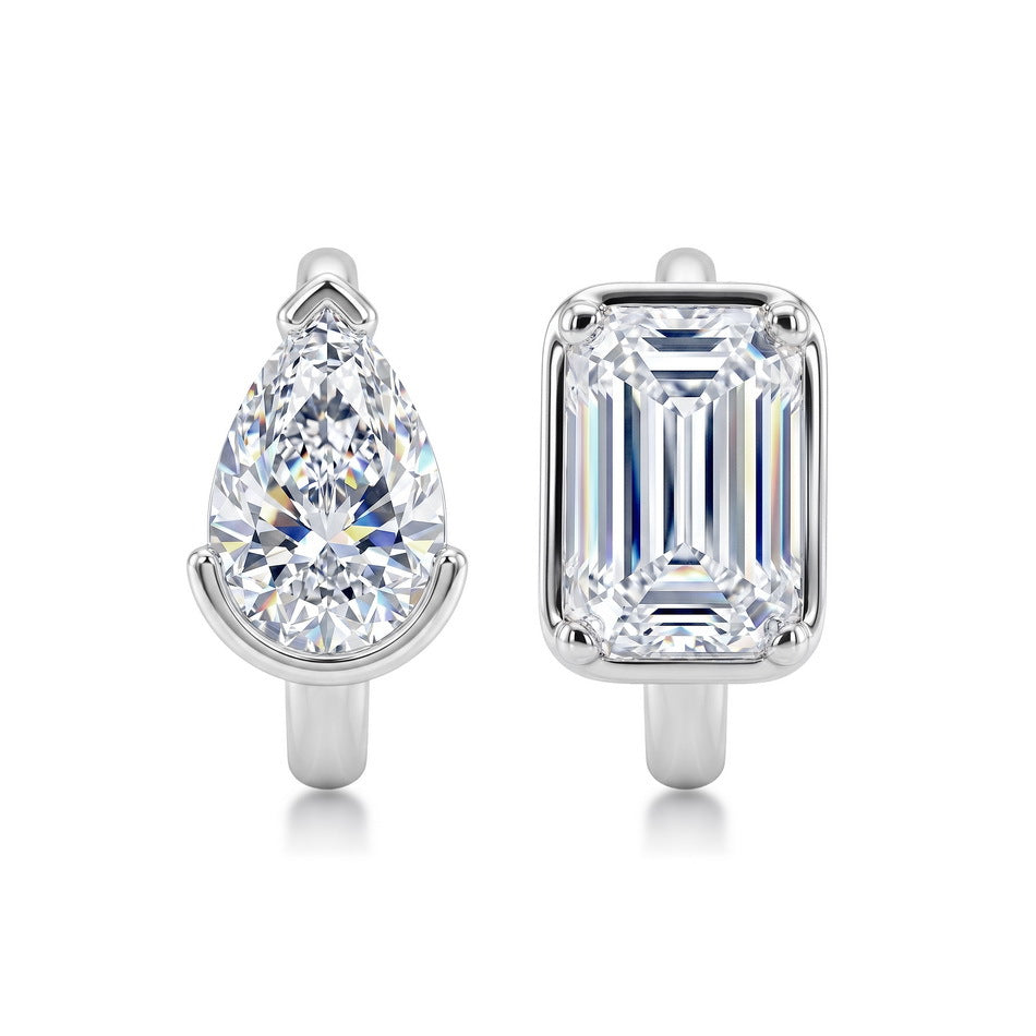 Mismatched pear and emerald cut lab grown diamond bezel huggie hoop earrings in 925 sterling silver.