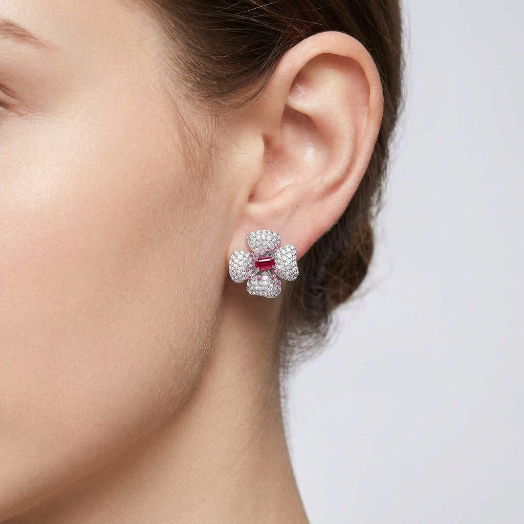 American woman wearing ruby flower stud earrings with a casual chic outfit.