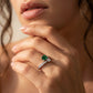 Close-up editorial portrait lifestyle view of a model displaying a modern two-stone emerald Toi et Moi ring.