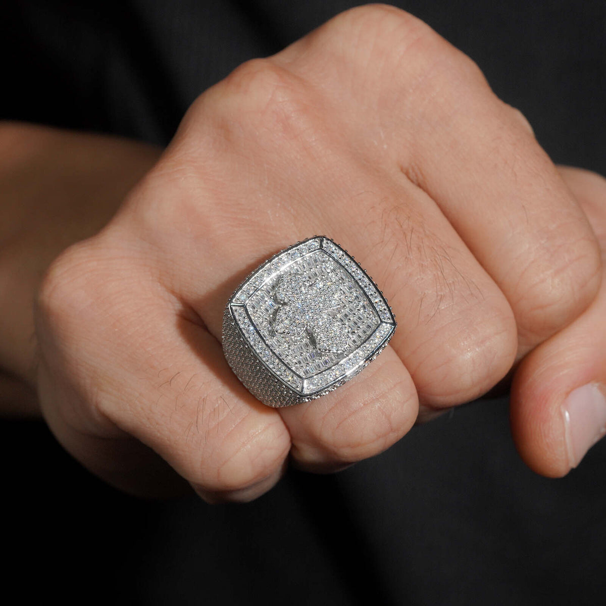 Model wearing S925 sterling silver iced out moissanite baguette cushion cross signet ring on fist