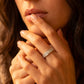 Close up lifestyle shot of a model featuring the double row pavé moissanite eternity wedding band.