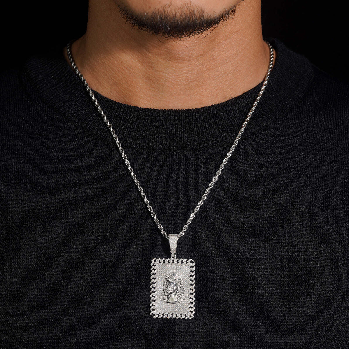 Hand wearing black glove holding S925 silver iced out moissanite Jesus rectangular dog tag pendant   
