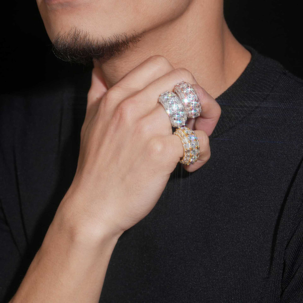 Model wearing layered S925 sterling silver iced out round baguette moissanite 3-row band rings on fingers