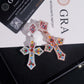 Rose gold and silver S925 multi-color moissanite cross pendants leaning against GRA certificate card