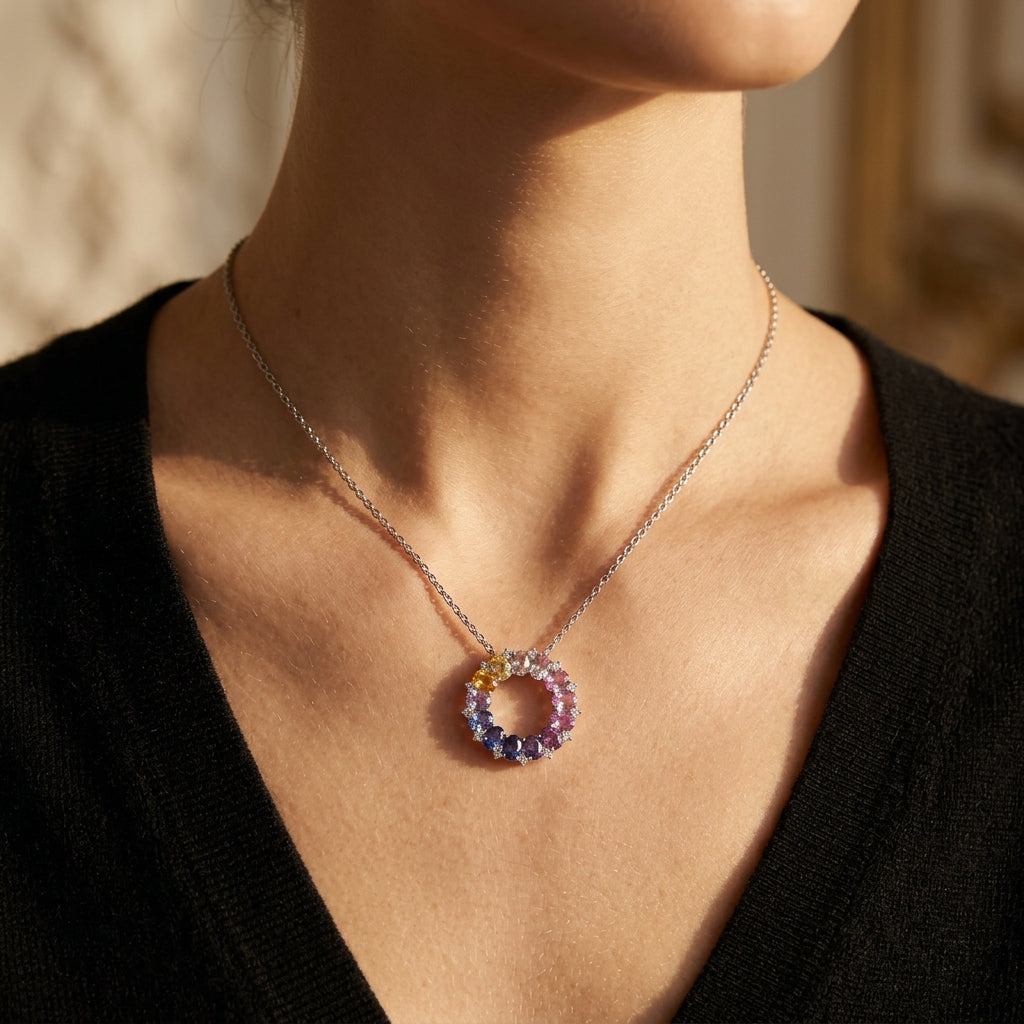 Model wearing multi-color oval cut rainbow gemstone circle pendant necklace.
