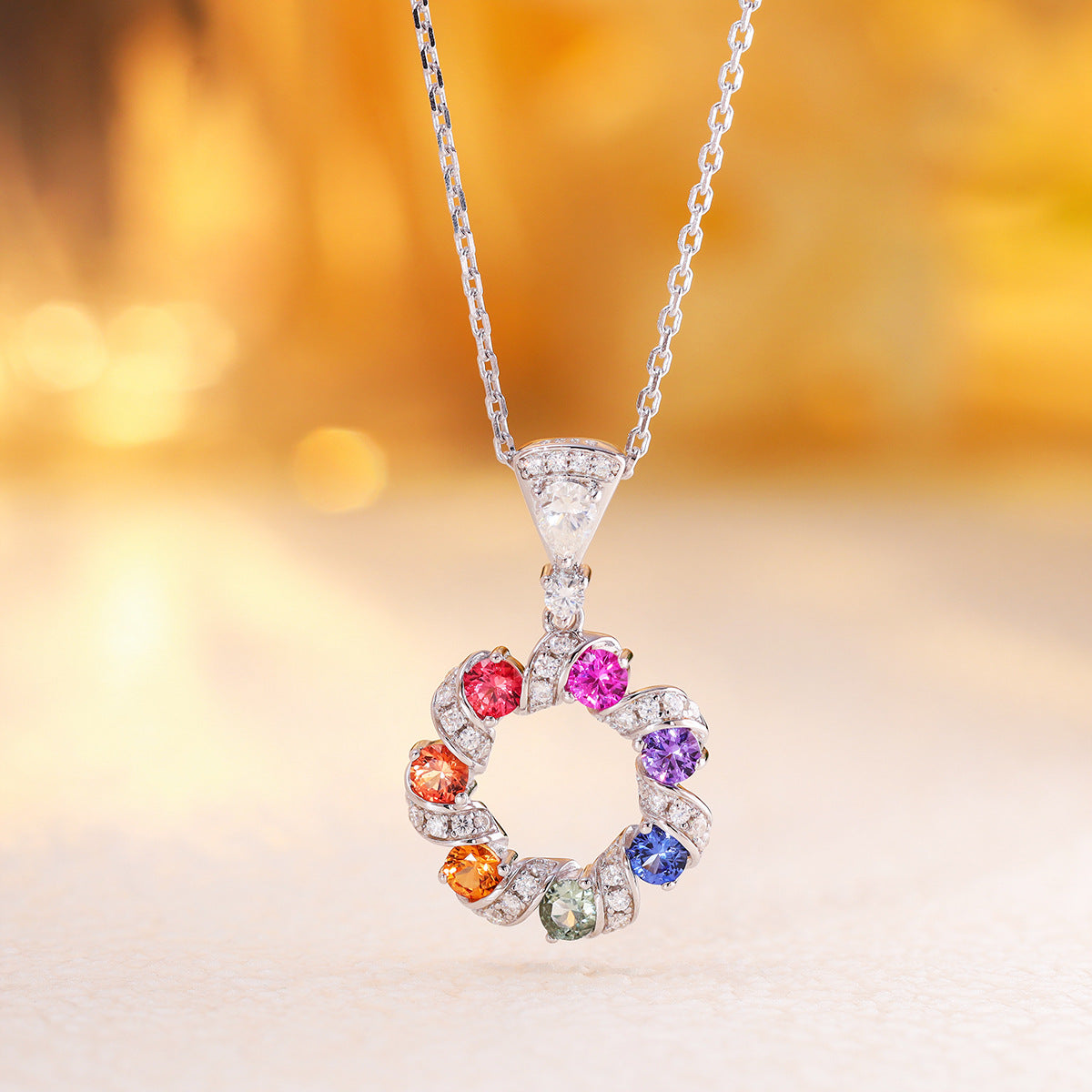 Hanging shot of multi-color sapphire wreath circle pendant necklace on delicate chain.