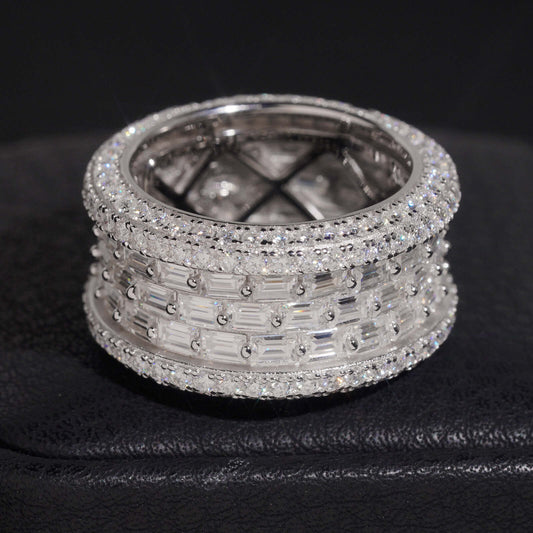 Multi row baguette and round moissanite wide eternity band ring in sterling silver isolated on dark background