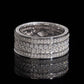 Front view of multi row micro pave moissanite wide eternity band ring on dark background