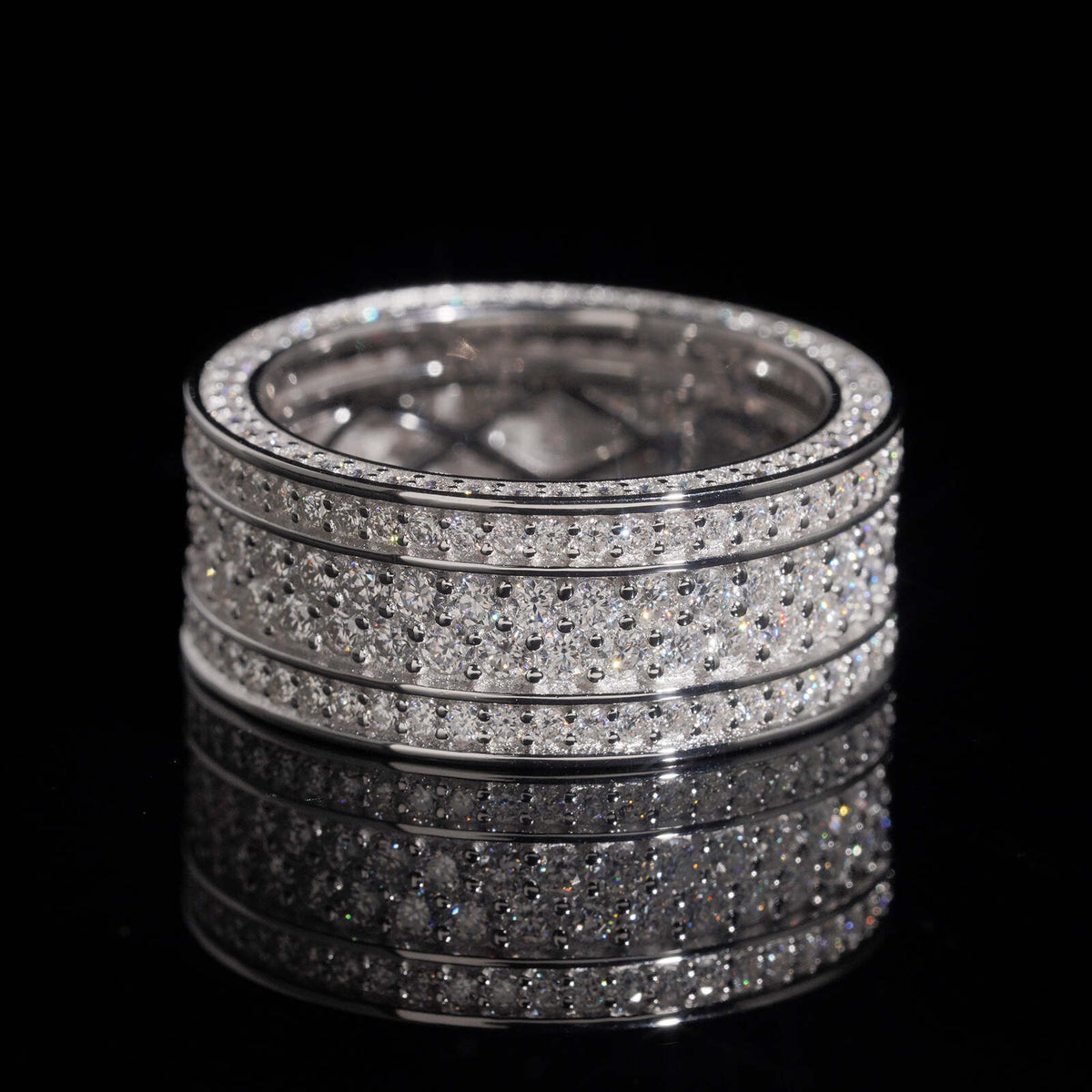 Front view of multi row micro pave moissanite wide eternity band ring on dark background