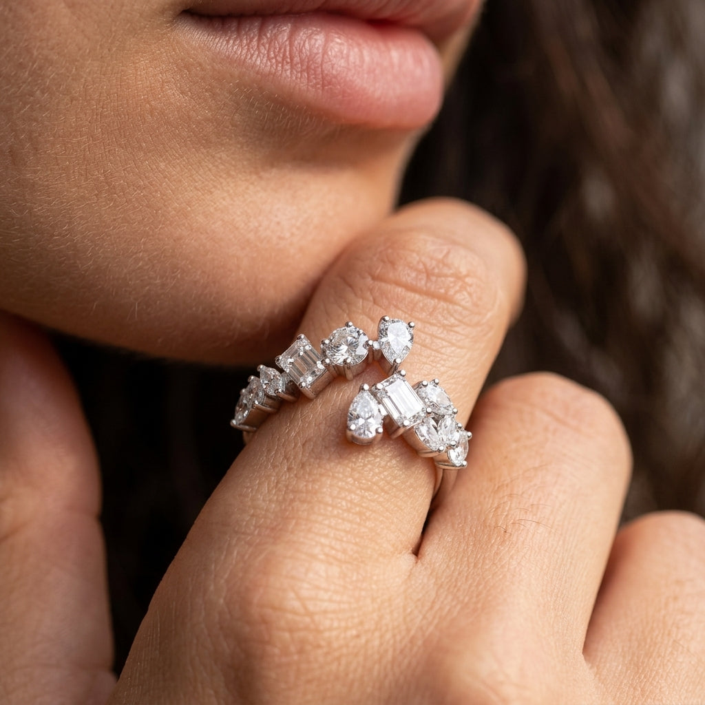 Model wearing mixed cut multi-shape moissanite open bypass ring on hand.