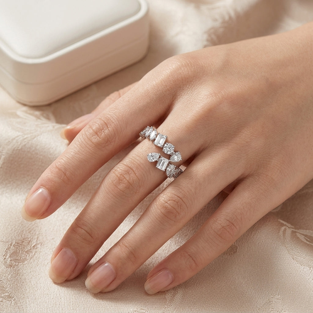 Close-up view of model wearing multi-shape moissanite open bypass statement ring.