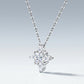 Perspective view of multi-shape moissanite compass star pendant necklace on slate background.