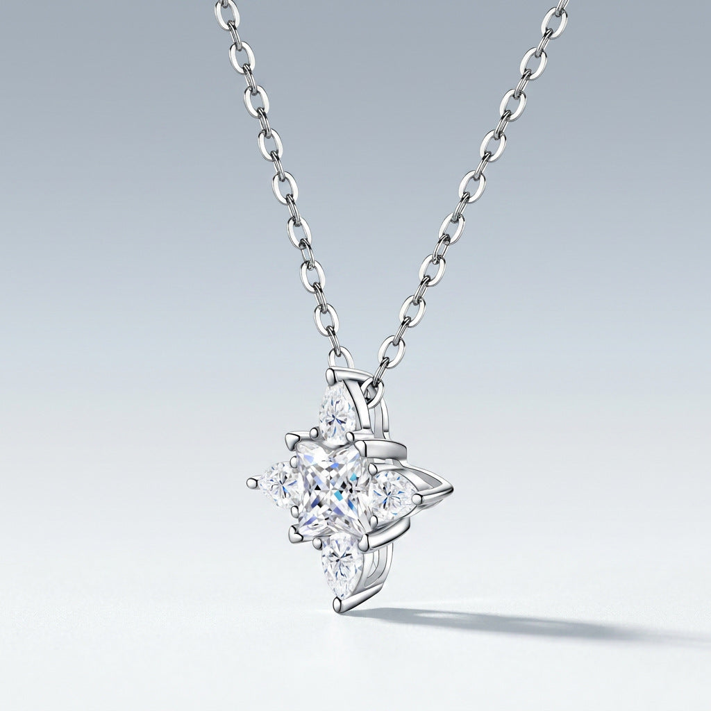Perspective view of multi-shape moissanite compass star pendant necklace on slate background.