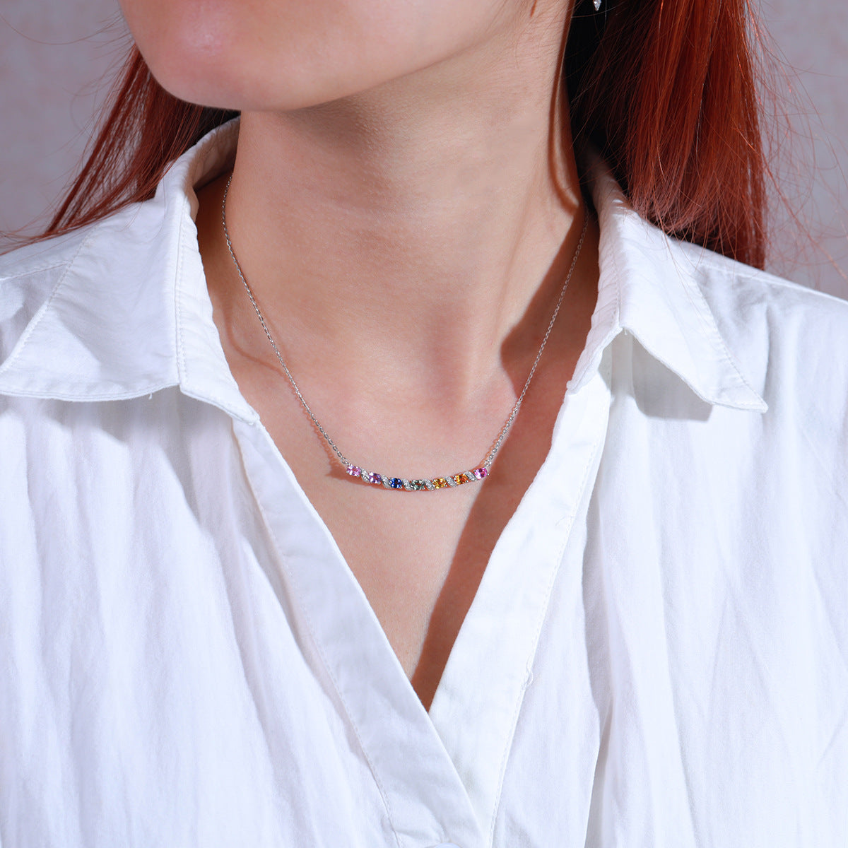 Model wearing multicolor gemstone and moissanite rainbow bar necklace