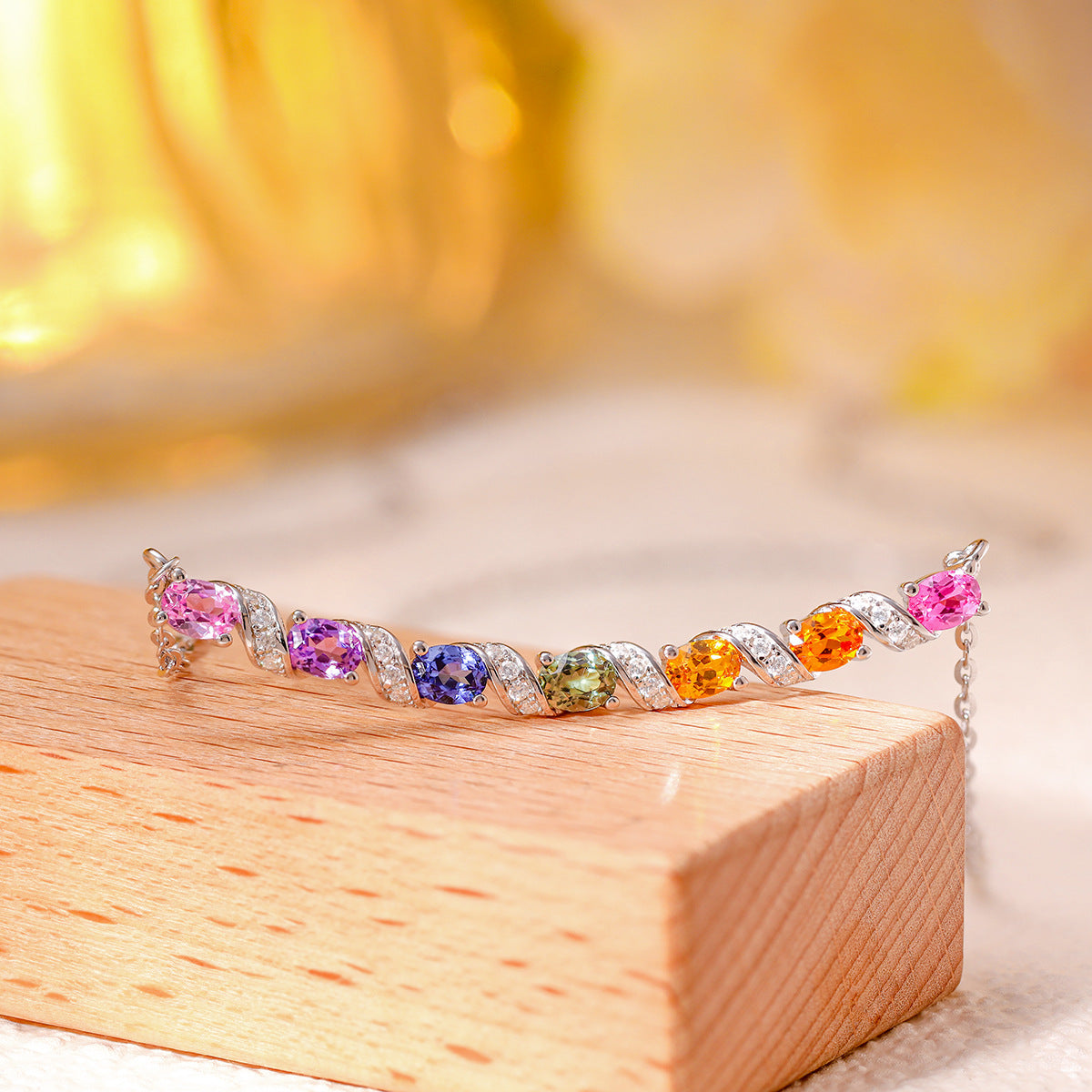 Side view of multicolor gemstone and moissanite rainbow bar necklace displayed on wooden stand