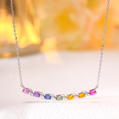 Multicolor gemstone and moissanite rainbow bar necklace in sterling silver in warm ambient lighting