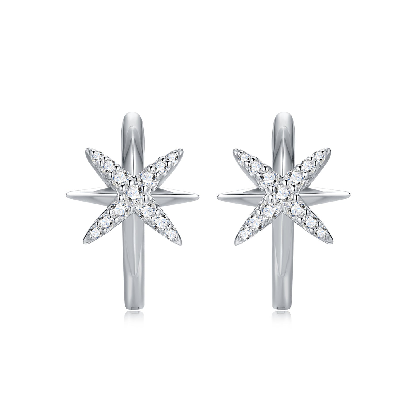North star moissanite huggie hoop earrings with celestial starburst pave setting on white background.