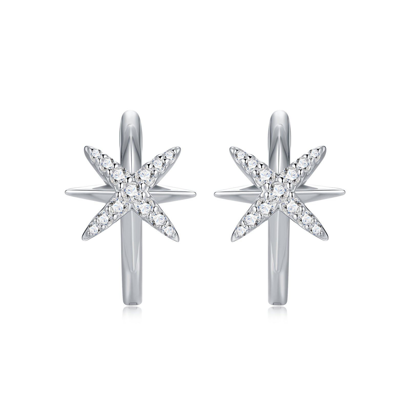 North star moissanite huggie hoop earrings with celestial starburst pave setting on white background.