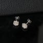 Angle view of octagonal scalloped halo lab diamond stud earrings showing posts and butterfly backings.