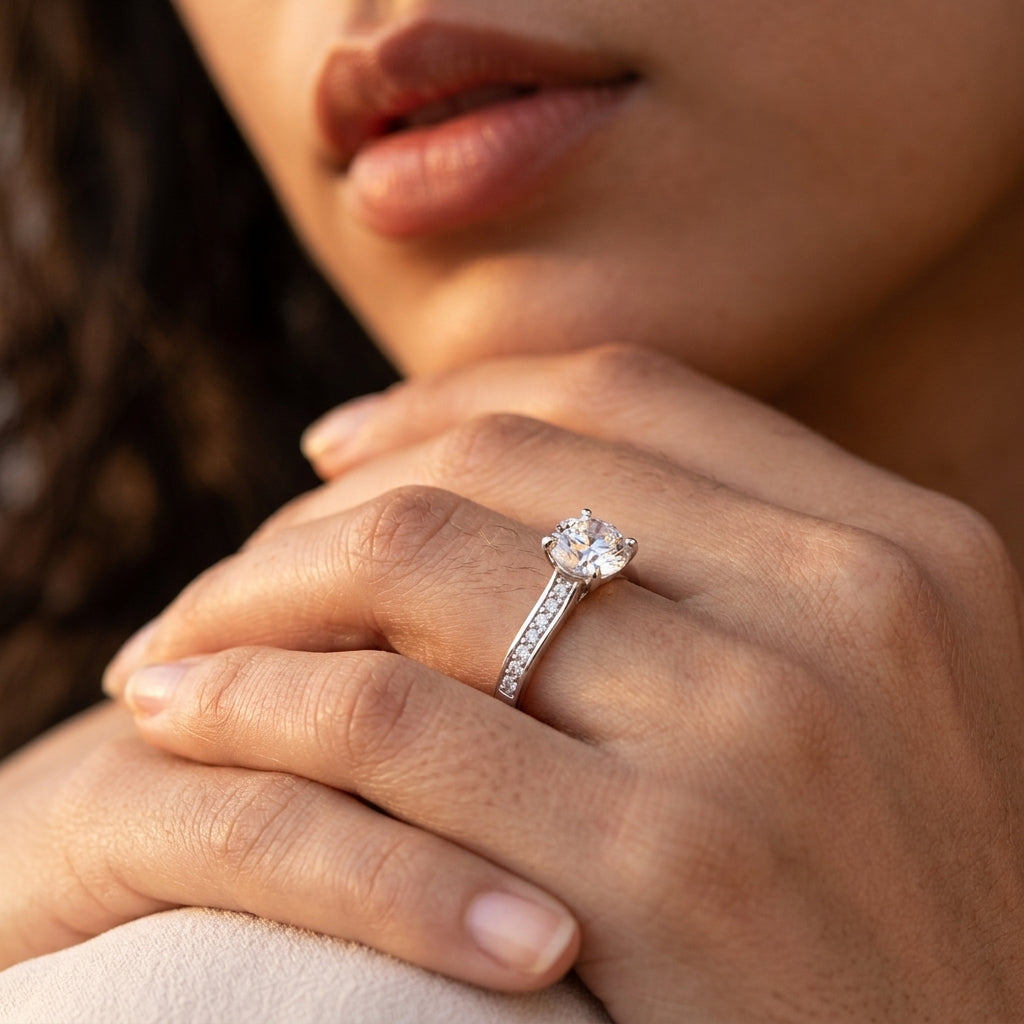 Fine jewelry lifestyle shot highlighting an old money aesthetic brilliant sparkle statement bridal jewelry ring on a model's hand.