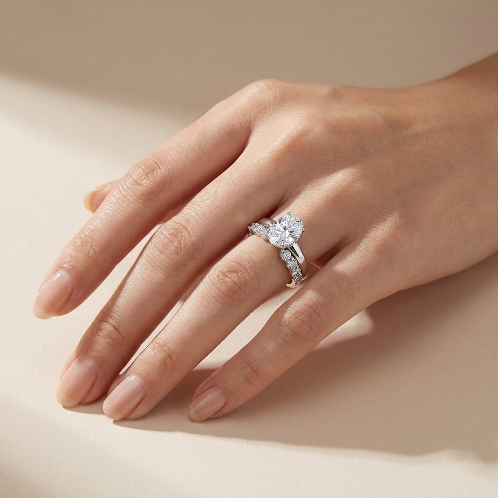 Lifestyle view of model showcasing oval lab grown diamond engagement ring and curved accent band set.