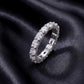 Angled profile view of oval cut lab-grown diamond eternity band ring on dark silk.