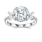 Studio top view display showcasing the symmetrical marquise floral cluster side stones framing an oval cut moissanite.