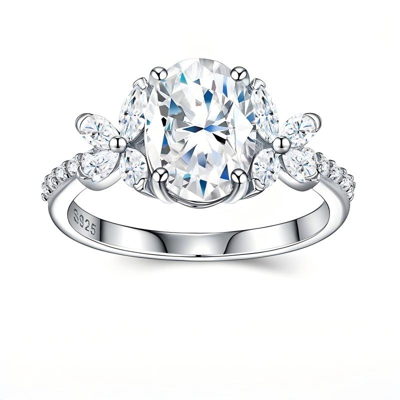 Studio top view display showcasing the symmetrical marquise floral cluster side stones framing an oval cut moissanite.