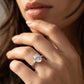 Close-up view of a model wearing minimalist oval cut moissanite solitaire promise ring.