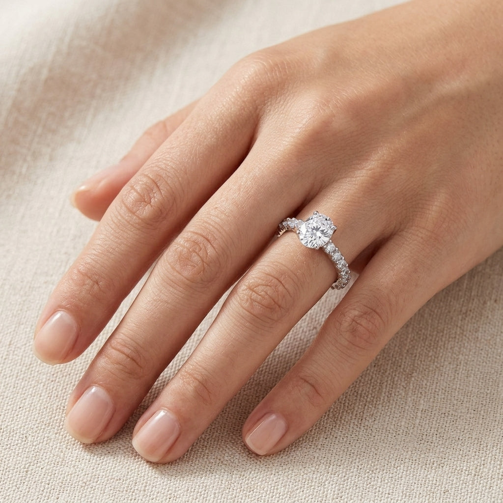 Model wearing oval cut lab grown diamond pave band solitaire engagement ring.