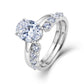Model wearing oval lab grown diamond engagement ring and curved accent wedding band.