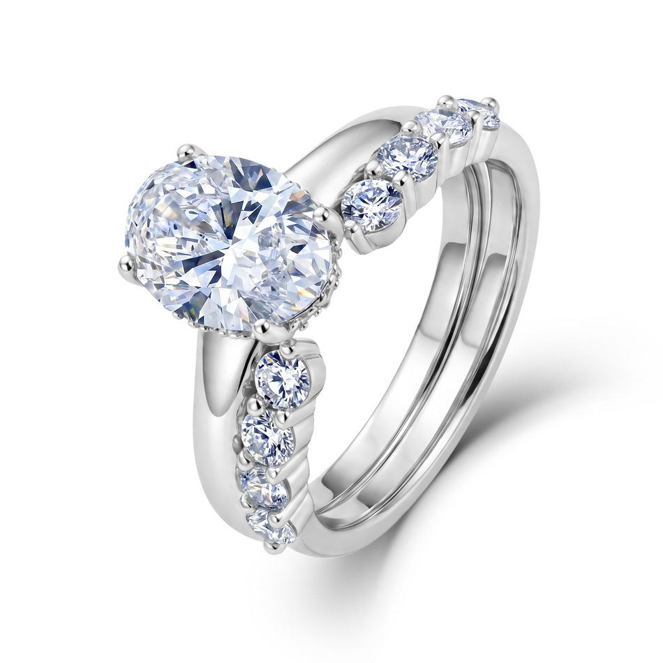 Model wearing oval lab grown diamond engagement ring and curved accent wedding band.