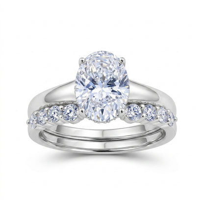 Oval lab grown diamond engagement ring and curved accent wedding band set in 925 silver.