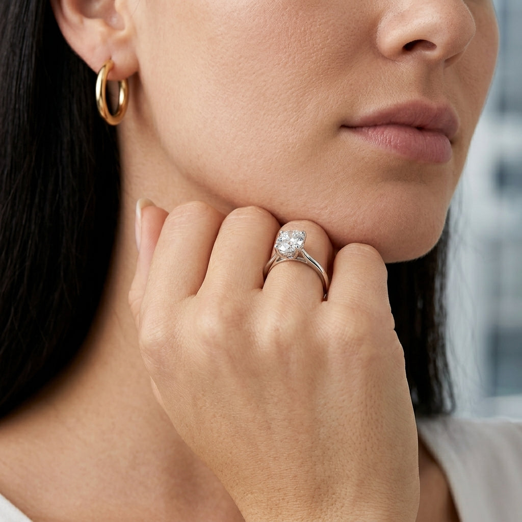 Lifestyle view of model displaying oval cut lab grown diamond minimalist plain ring.