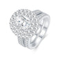 Silver oval moissanite double halo ring paired with matching milgrain pave wedding band.