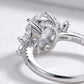 Studio close-up view showing the under-gallery basket setting and S925 hallmark of an oval moissanite floral cluster ring.
