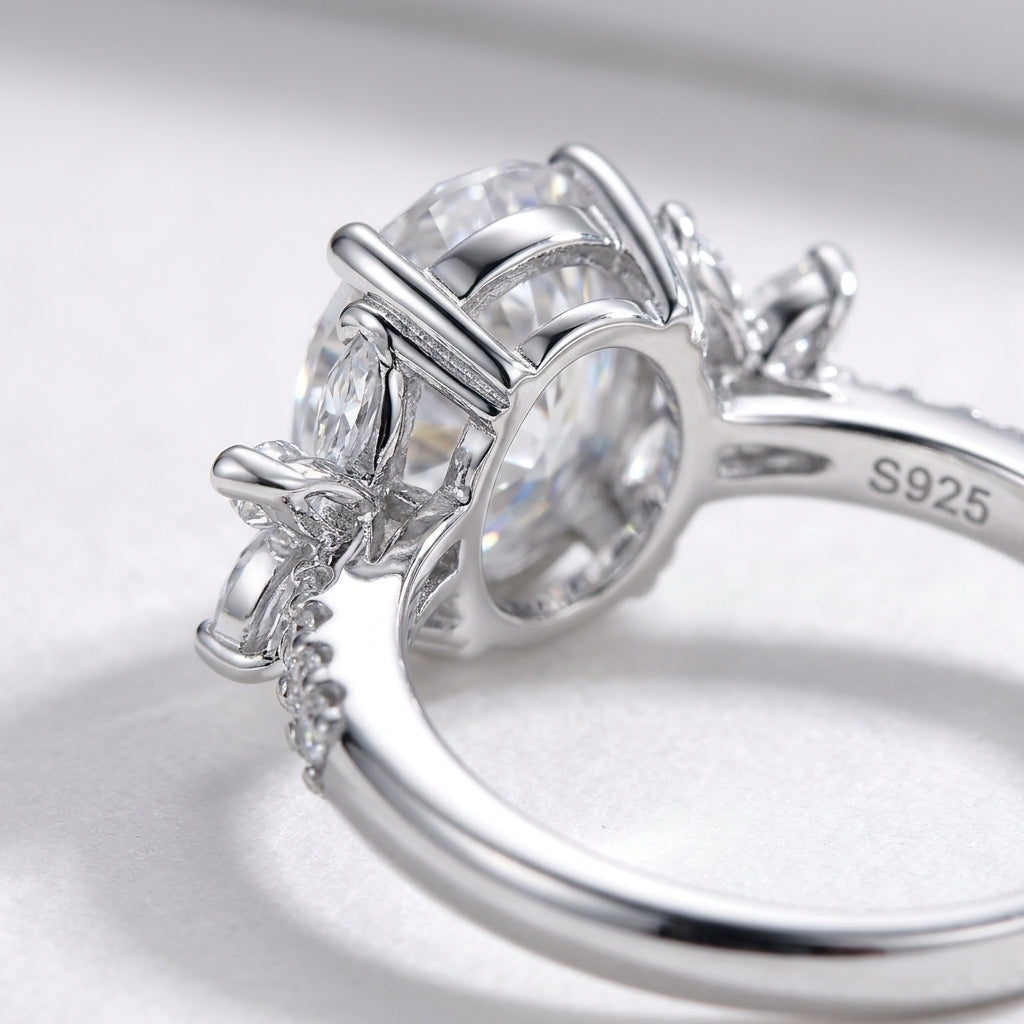 Studio close-up view showing the under-gallery basket setting and S925 hallmark of an oval moissanite floral cluster ring.