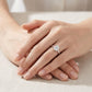 Model showing oval cut moissanite solitaire ring on hand in soft natural lighting.