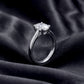 Side basket view of oval lab grown diamond plain band solitaire ring on dark silk.