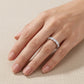 Full hand shot of model displaying oval seven-stone shared-prong stacking ring.